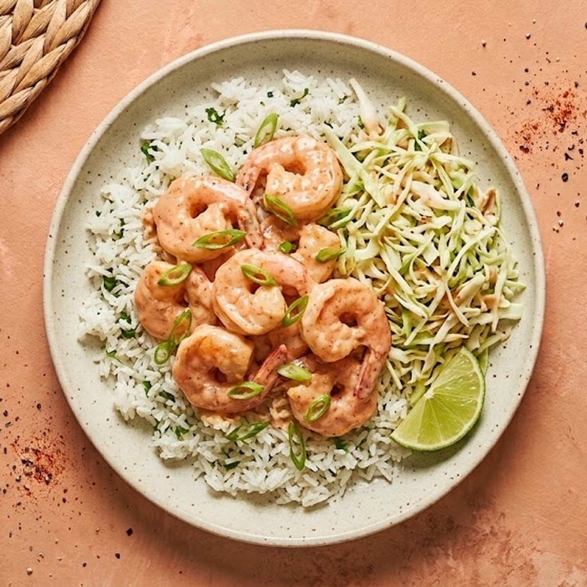 Bang Bang Shrimp Bowl — Gulf shrimp in creamy bang bang sauce over cilantro-lime rice with cabbage slaw and lime