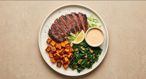 Bourbon Street - sliced grass-fed skirt steak with roasted sweet potatoes, garlic kale and Creole Cajun sauce
