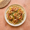 Cajun Shrimp Alfredo — seared Gulf shrimp over penne in creamy Cajun Alfredo with red, yellow and green bell peppers