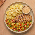 Cowboy Skillet — char-grilled halal chicken, scrambled eggs with mozzarella, and diced baby potatoes with peppers, boom boom sauce on the side