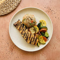 Hibachi Salmon — seared wild-caught salmon with spicy mayo drizzle and black sesame over coconut aminos fried rice, with charred zucchini, yellow squash, carrot and broccoli
