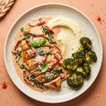 Marry Me Chicken — sliced halal chicken breast in a creamy sun-dried tomato parmesan sauce with spinach and basil, served with mashed potatoes and roasted broccoli
