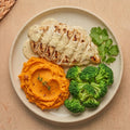 Parma — grilled halal chicken breast in garlic parmesan sauce with mashed sweet potatoes and steamed broccoli