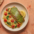 Pesto Salmon — basil pesto crusted wild-caught salmon over lemony orzo with blistered cherry tomatoes and baby spinach