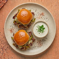 Philly Sliders — shaved beef with melted cheese, green peppers and onions on mini brioche buns, with a side cup of ranch