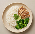 Playground — grilled chicken breast, jasmine rice, and steamed broccoli on a cream plate