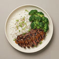 Teriyaki Steak — teriyaki-glazed skirt steak with jasmine rice, steamed broccoli, green onions, and sesame