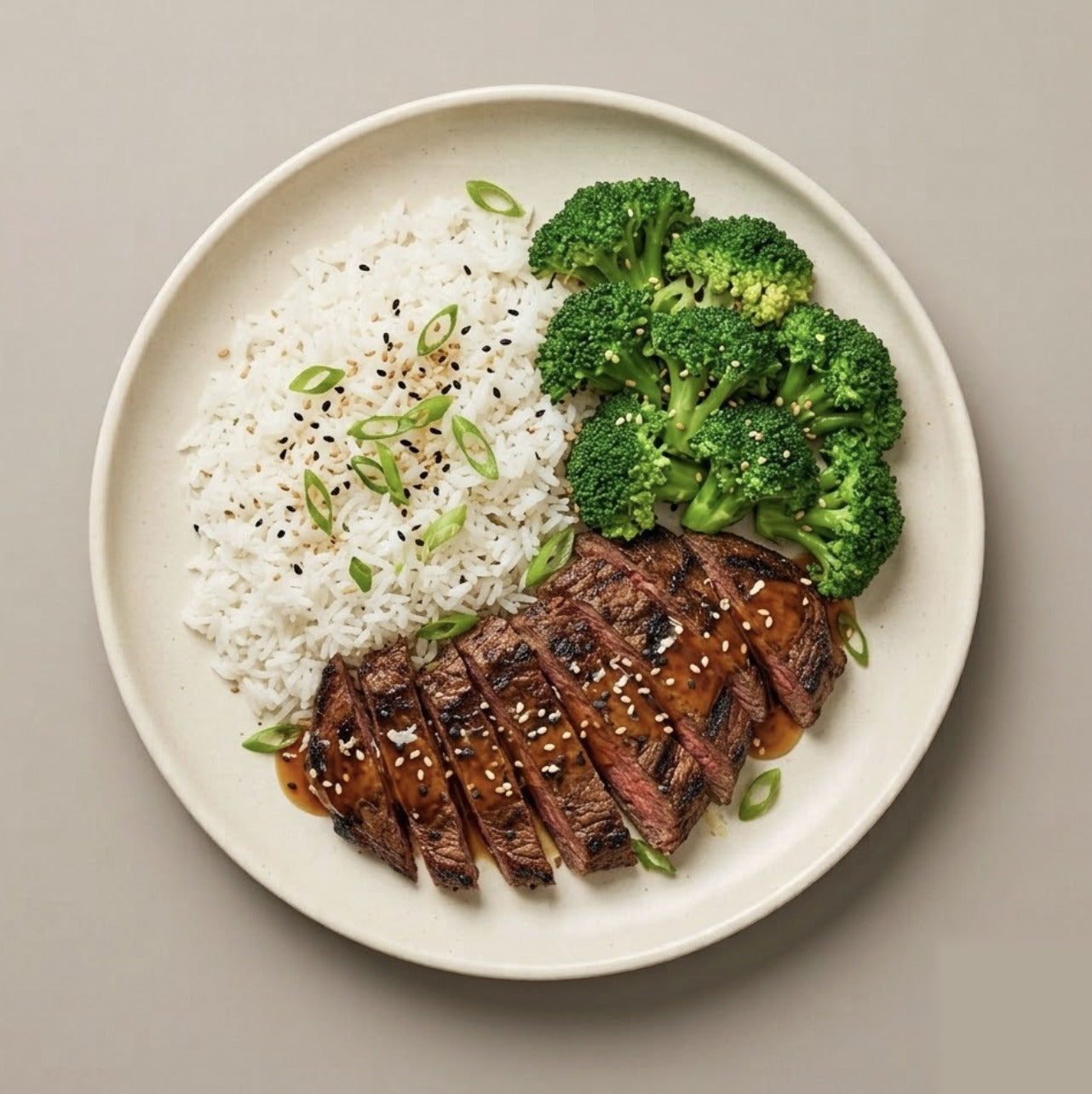 Teriyaki Steak — teriyaki-glazed skirt steak with jasmine rice, steamed broccoli, green onions, and sesame